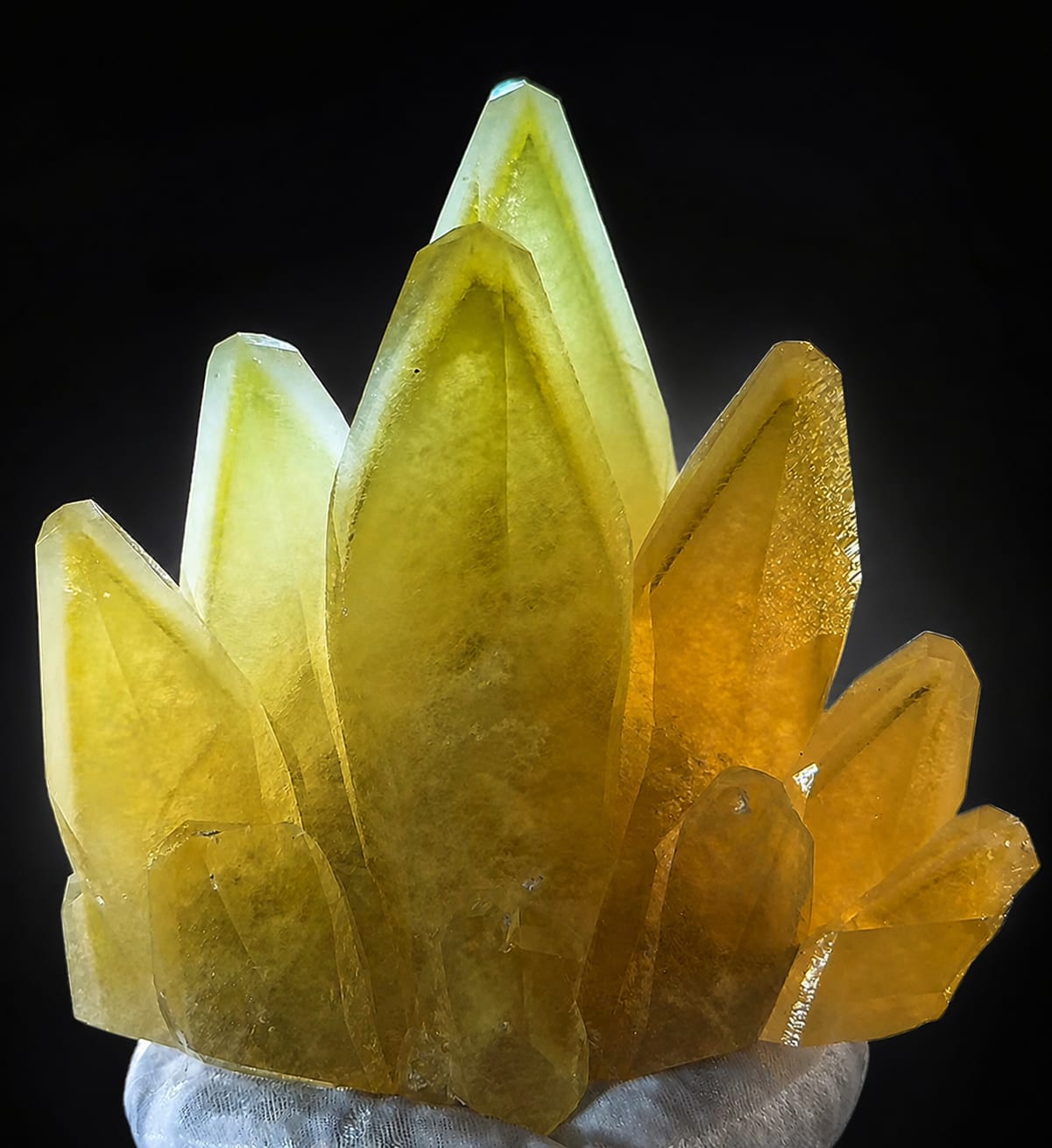 Golden calcite crystal group on a black background